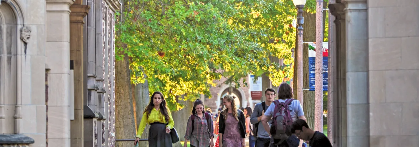 a sidewalk and archway with students